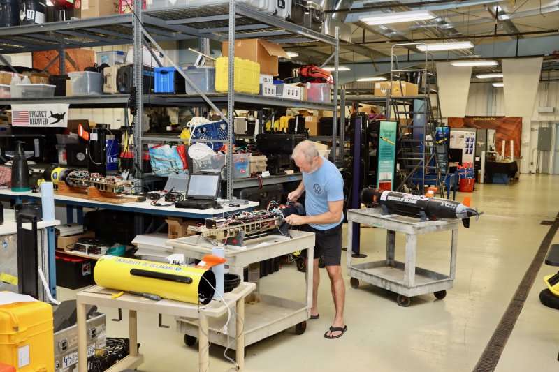 Erik White assembles an autonomous underwater vehicle in a shared workshop at the UD Lewes campus. The AUV is heading to the Marshall Islands, where Project Recover will look for a missing B-25 bomber.